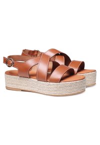Sandali platform in pelle marrone con cinghie incrociate, fibbia alla caviglia e suola in tessuto di corda intrecciato.