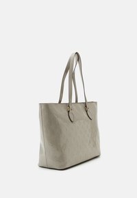 Sac fourre-tout beige avec motif floral embossé, matériau synthétique, deux bretelles, quincaillerie dorée et forme rectangulaire structurée.