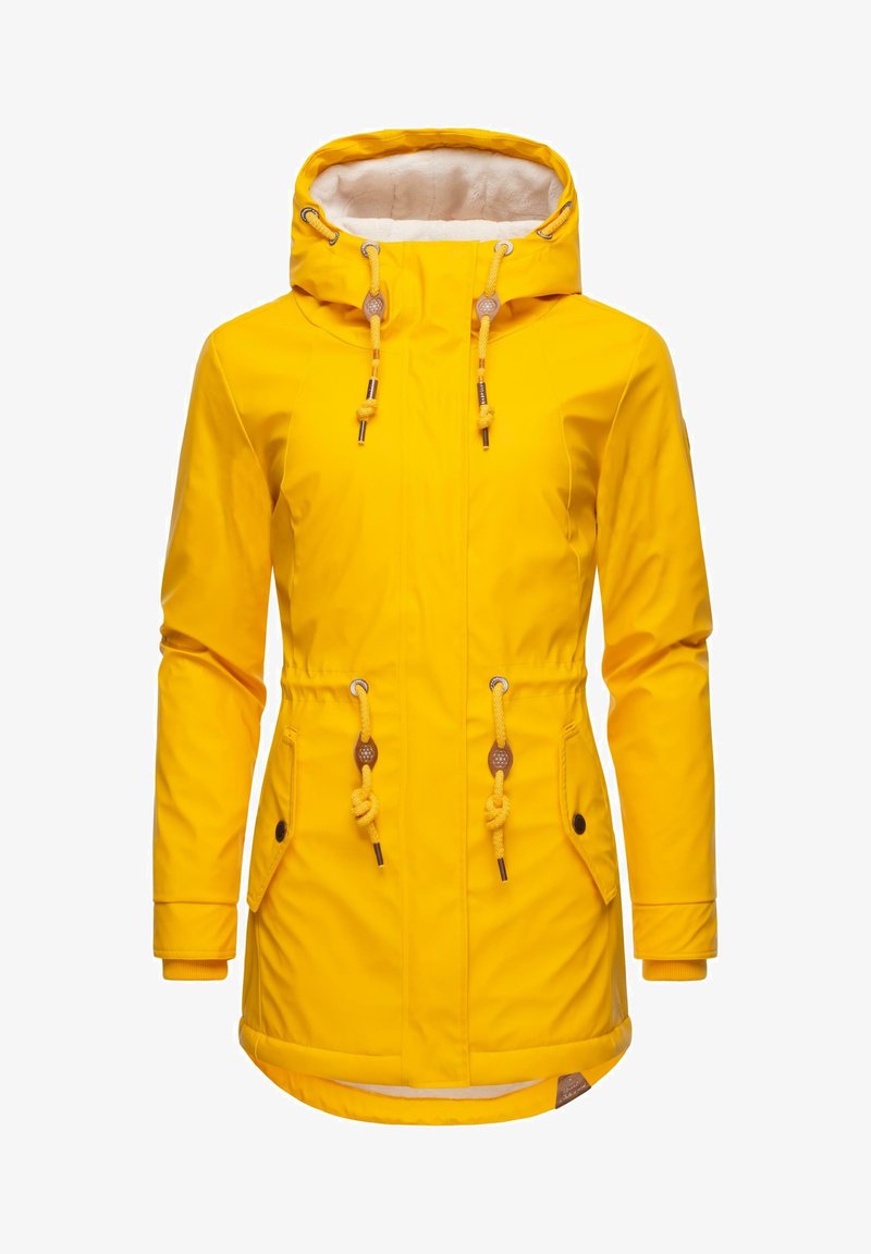 Keltainen vedenpitävä takki, jossa on fleecevuorattu huppu, kiristyskuminauhat, kaksi etutaskua ja elastiset hihansuut. Sujuva pinta ja keskipitkä malli.