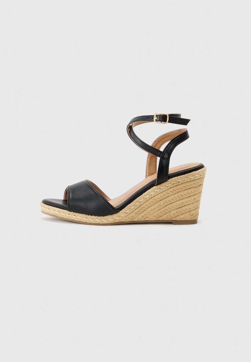 Black leather wedge sandal with an open toe, jute-wrapped heel, and crisscross ankle straps. Smooth texture with a light brown insole.