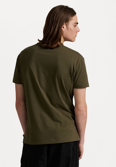 Olive green cotton t-shirt with short sleeves, crew neck, and a relaxed fit. The fabric appears smooth and plain, without any visible patterns.