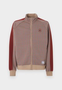 Ζακέτα με φερμουάρ και καρό μοτίβο σε πορτοκαλί και μπεζ, με κόκκινα μανίκια και ριμπ μανσέτες. Διαθέτει ταμπά φερμουάρ και λεπτομέρεια με λογότυπο.