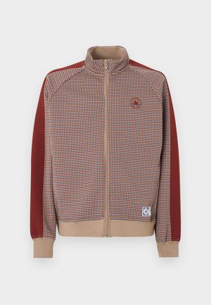 Veste zippée avec un motif à carreaux orange et beige, manches rouges unies et poignets côtelés ; fermeture éclair beige et détail de logo.