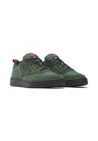 Green suede sneakers with black rubber soles, featuring a padded collar, round toe, and contrasting orange and purple accents on the tongue.