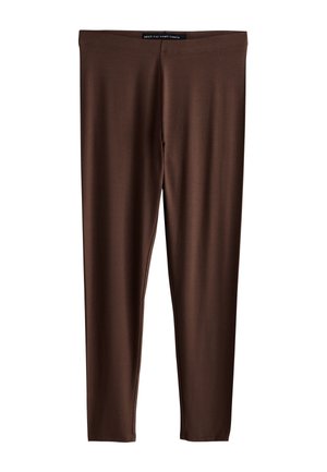 Leggings marron longueur totale en matière lisse et extensible avec une taille élastique. Présentent un design sans coutures ni éléments visibles.