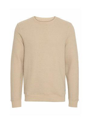 Šviesiai rudas megztinis su tekstūruotu, vaflinio pintinės dizainu. Turi apvalų kaklą, ilgomis rankovėmis, o rankogaliai ir apatinė dalis yra gumuoti, kad geriau priglustų.