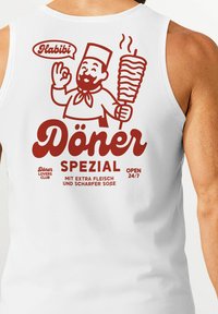White tank top featuring red graphic design with a chef holding a döner kebab, text reading “Döner Spezial” and “Open 24/7.”