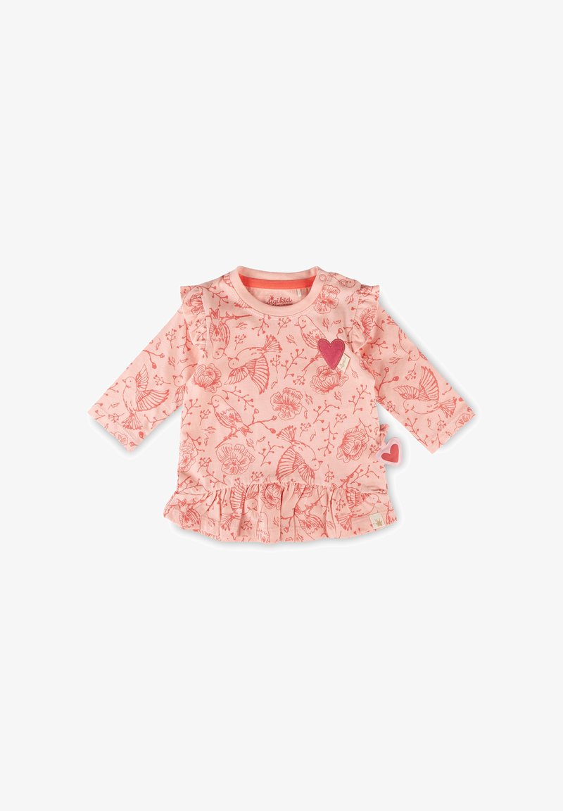 Haut bébé rose à manches longues avec motifs d'oiseaux et de fleurs, ourlet volanté, et deux petites patches en forme de cœur sur la poitrine et le côté.
