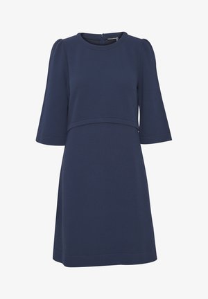 Tumedast sinine kleit ümmarguse kaelusega, kolmeveerand pikkade puffvarrukatega, tekstuurse kangaga ning kitsas ülaosa, millel on laienev seelik.