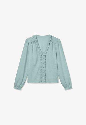 Lys blå bluse med lange ermer, med volangkant langs V-halsen, knappestolpe foran, skuldersømmer og elastiske mansjetter.