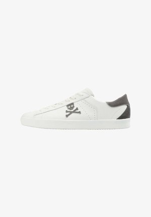 White leather sneakers featuring a skull and crossbones logo, grey suede heel accents, flat laces, and a textured rubber sole.