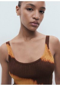 Ribbed tank top featuring a blend of brown and orange tie-dye patterns. It has thin straps and a rounded neckline. Smooth texture.