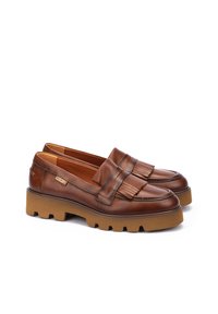 Mocasines de cuero marrón con detalle de flecos, suela de goma tipo lug y acentos cosidos. Acabado suave y diseño de punta redondeada.