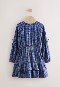 Vestito a quadri blu con dettagli gialli, maniche lunghe a sbuffo, vita con coulisse e orlo arricciato. Presenta una chiusura con bottoni sul retro.