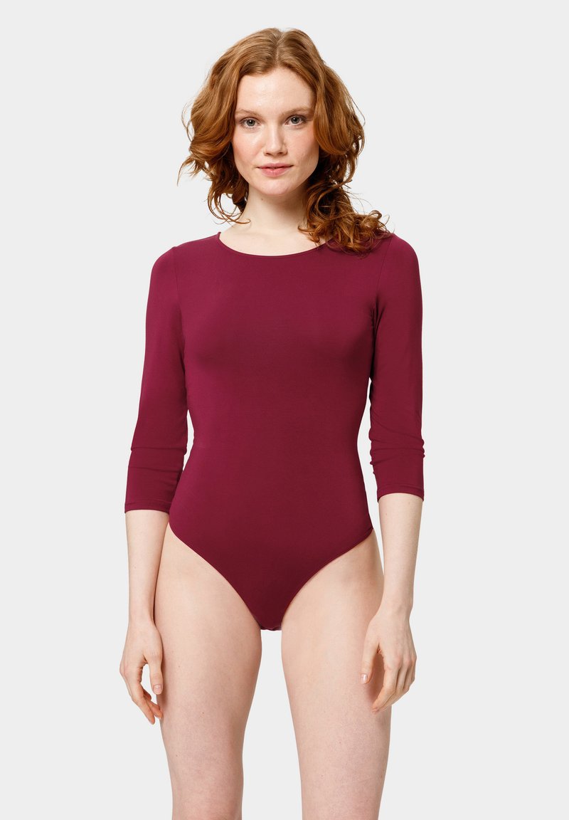 Bodysuit bordeaux à manches longues avec un col rond, design moulant, texture lisse et ouvertures de jambes taille haute pour une silhouette élégante.