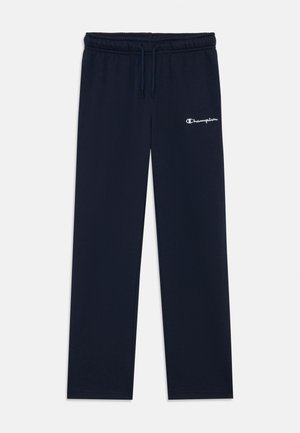 Mornarsko modri Champion trenirka s elastičnim pasom, vrvico in belim logotipom na zgornji levi stegn, razpostavljena na beli podlagi.