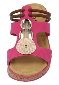 Sandal rosa con tre accenti metallici circolari e cinghie marroni. Texture in sughero sulla suola, design piatto. Fodera interna morbida.