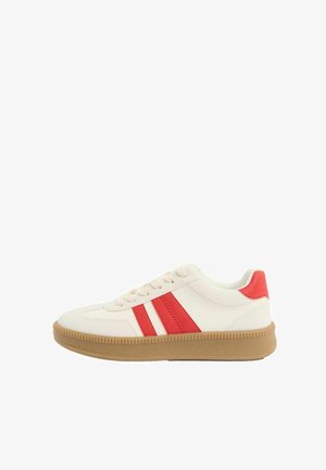 Zapatilla blanca con rayas rojas y detalle en el talón, suela texturizada beige y cierre con cordones, vista lateral sobre fondo blanco.