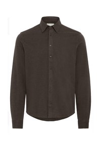 Mørkebrun langermet skjorte med klassisk krage, frontlukking med knapper og avrundet nederkant. Laget av et mykt, teksturert stoff.