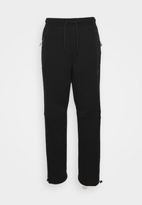 Svarta sweatpants gjorda av ett mjukt material; har en elastisk midja med dragsko, sidofickor och avsmalnande ben med justerbara muddar.