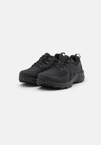 Baskets de sport noires avec tige en maille synthétique, tissu texturé, bouts renforcés et semelles en caoutchouc robustes pour une meilleure adhérence.