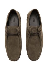 Brown suede slip-on shoes with a rounded toe, subtle stitching, and leather laces accenting the upper for a casual, comfortable design.