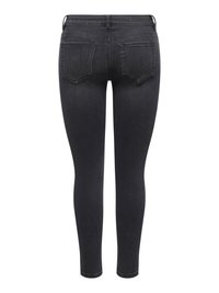 Jean skinny noir avec poches arrière, passants de ceinture et coutures visibles, montré de dos sur un fond blanc.