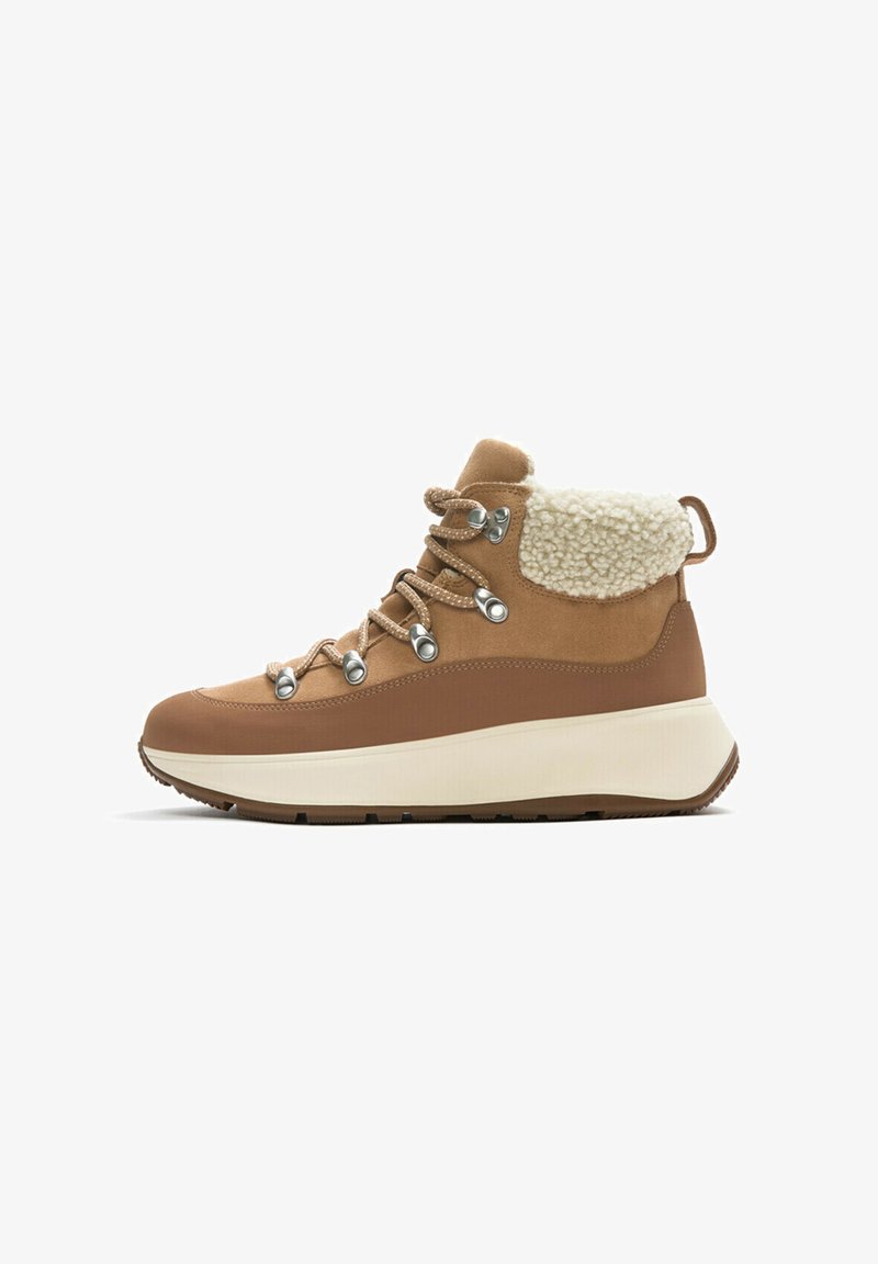 Brown hiking boots with a lace-up design, featuring a fluffy cream collar, silver eyelets, and a white midsole. Textured fabric upper.