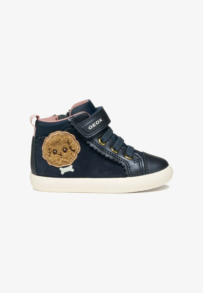 Zapatillas altas de color azul oscuro con un parche de galleta de dibujo animado en color beige, suela de goma blanca, diseño con cordones y correa de velcro para un ajuste seguro.