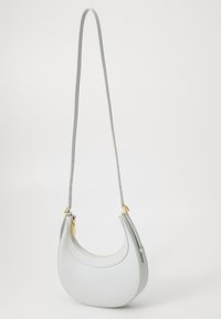 Light grey leather crossbody bag with a crescent shape, textured finish, and gold hardware accents. Adjustable strap for versatility.