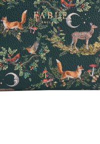 Dark green faux leather wallet featuring illustrations of foxes, birds, a deer, and mushrooms amid foliage, labeled "FABLE ENGLAND."