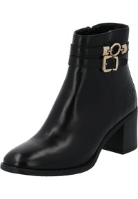 Černé kožené kotníkové boty s špičatou špičkou, zlatými přezkami na pasech a vrstveným podpatkem. Hladký povrch s embosovaným logem.