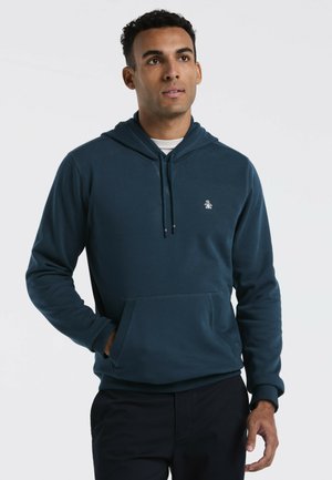 Marineblaue Kapuzenjacke aus weichem Stoff, mit Kängurutasche, Kordelzugkapuze und kleinem Logo auf der Brust.