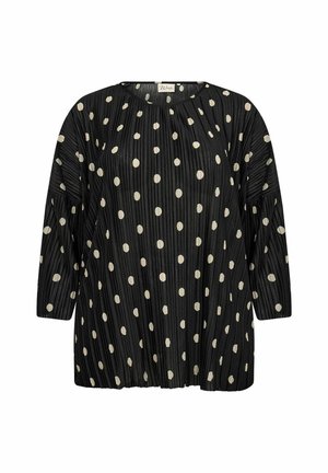 Czarna plisowana bluzka z rękawami do trzech czwartych, pokryta białymi kropkami. Okrągły dekolt i luźny krój. Miękka tekstura.