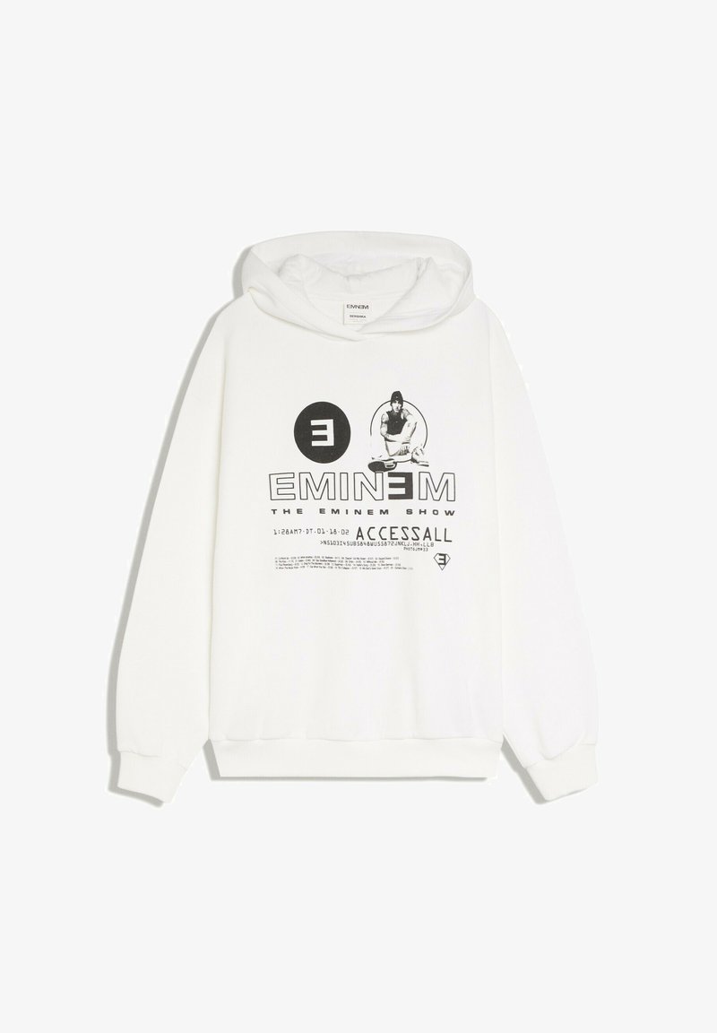 Sweat à capuche blanc avec motif Eminem noir, comprenant une figure assise, un logo et un texte faisant référence à "The Eminem Show" et "ACCESSALL."