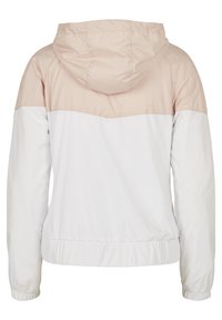 Vue arrière d'une veste légère avec une capuche beige et le haut du dos, ainsi que la partie inférieure blanche du corps et des manches, avec des poignets et une ceinture élastiques.