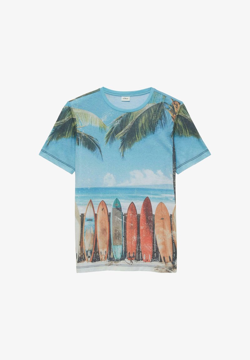 T-shirt bleu avec des palmiers imprimés, des planches de surf alignées sur une plage de sable et des vagues océaniques sous un ciel partiellement nuageux.