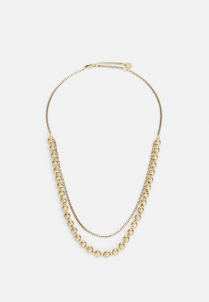 Gold necklace featuring two strands; one with smooth, round beads and the other with a textured, linked design. Adjustable clasp.