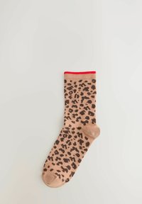 Single beige sock with dark brown leopard spots and a red top cuff, laid flat on a light gray background.