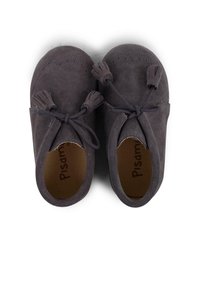 Zapatos de ante gris con puntera redondeada, que presentan borlas y detalles de cordones. Textura suave y diseño sencillo, adecuados para un uso casual.