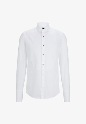 Valge pikakä sleeve shirt, millel on kõveres esipaneel, mustad nupud keskel ja klassikaline krae. Sile kangast tekstuur.