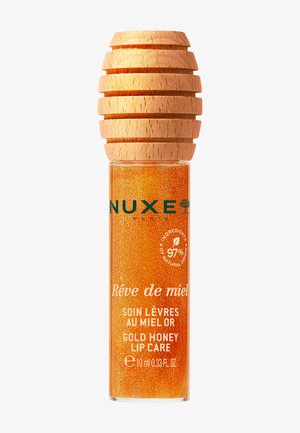 Nuxe Rêve de Miel gylden honning læbepleje med glitrende ravvæske og tekstureret trælåg, 10 ml flaske med mærkat med naturlige ingredienser.