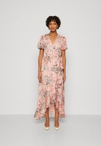 Floral print dress in pink, featuring ruffled sleeves, a wrap design, and an asymmetrical hem. Smooth fabric with subtle texture.