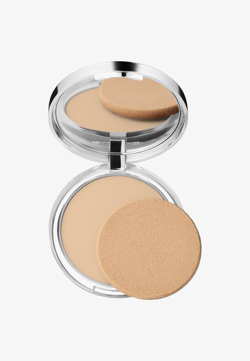 Kompaktpudder med et klart, rundt etuiet som inneholder et jevnt, lys beige pudder og en rund, myk svampapplikator.