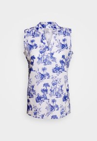 Hihaton valkoinen pusero, jossa sininen toile de Jouy -kuvio, jossa on palmuja ja arkkitehtonisia raunioita, V-kauluksella, näkyvä koko 36 -etiketti.