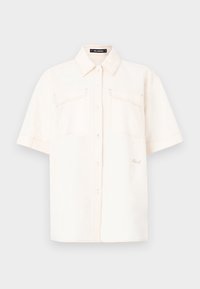 Camicia a maniche corte di colore crema, realizzata in tessuto leggero, con due tasche frontali, chiusura a bottoni e cuciture a contrasto.