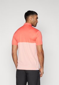Puma Golf PURE COLORBLOCK Polo shirt peach frost/pink fruit