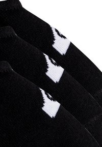 Zwarte gebreide sokken met witte logo's, met een gladde textuur en een sportief design. Het boorgedeelte heeft een goede pasvorm met versterkte stiksels.