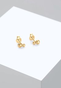 Gold-tone metal stud earrings featuring a round, polished design with two spherical accents and a post back closure.