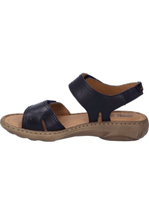 Navy leather sandals with two wide straps, open sides, and a padded insole. The sole is light brown with a textured finish.